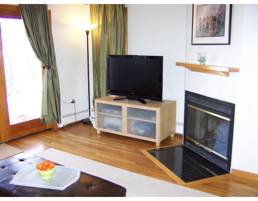 21 5th Avenue, Unit 21 Watertown, MA 02472 - Photo 3 of 15 a living room with a flat screen tv and a fireplace
