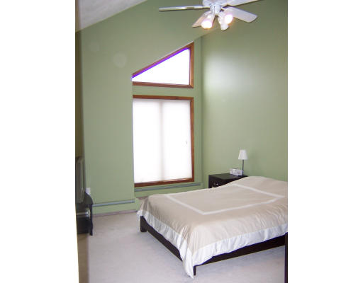 21 5th Avenue, Unit 21 Watertown, MA 02472 - Photo 5 of 15 a bedroom with a bed and a chandelier