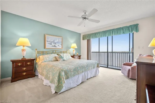 a bedroom with a bed and a dresser next to a window