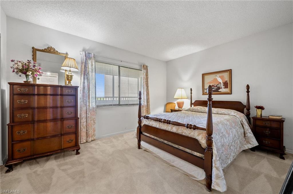 1900 Virginia Avenue, Unit 902 Fort Myers, FL 33901 - Photo 23 of 41 a bedroom with a bed and a cabinets