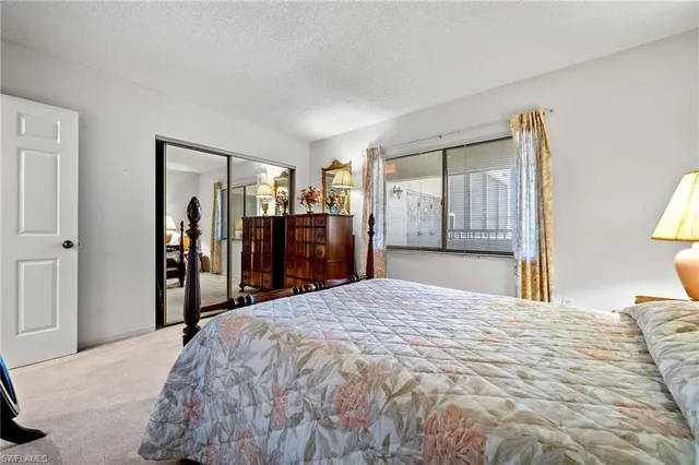 a bed room with a bed and a large mirror