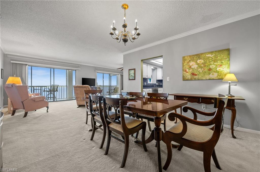 1900 Virginia Avenue, Unit 902 Fort Myers, FL 33901 - Photo 4 of 41 a view of a dining room with furniture and chandelier