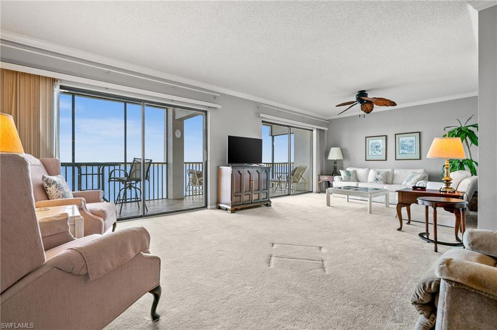 1900 Virginia Avenue, Unit 902 Fort Myers, FL 33901 - Photo 5 of 41 a living room with furniture and a flat screen tv