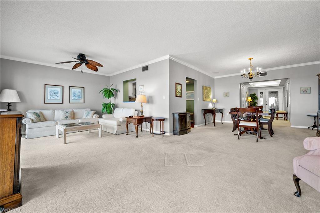 1900 Virginia Avenue, Unit 902 Fort Myers, FL 33901 - Photo 6 of 41 a living room with furniture and a chandelier