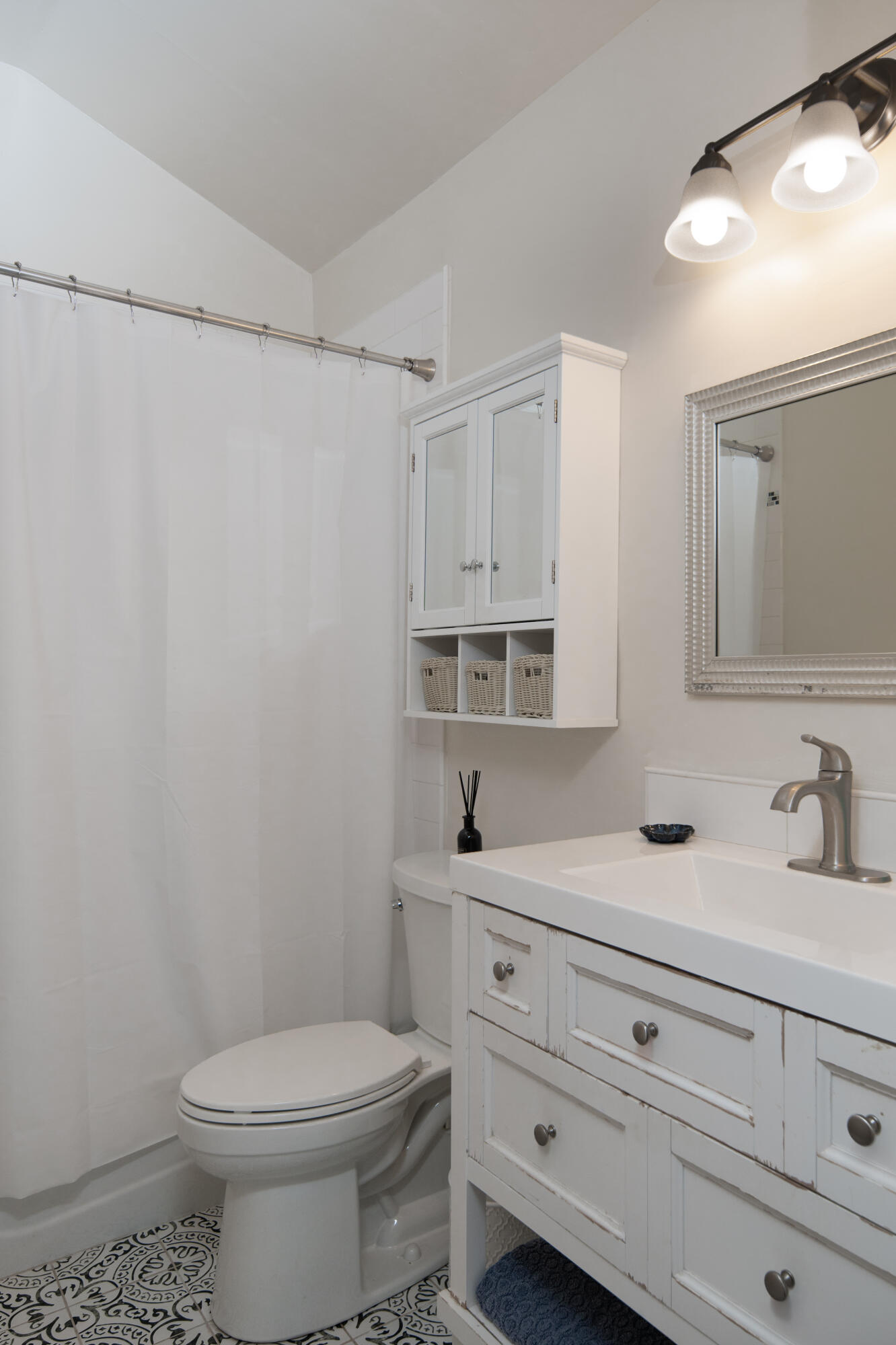 710 Ballard Canyon Road Solvang, CA 93463 - Photo 12 of 23 a bathroom with a sink a mirror and a toilet