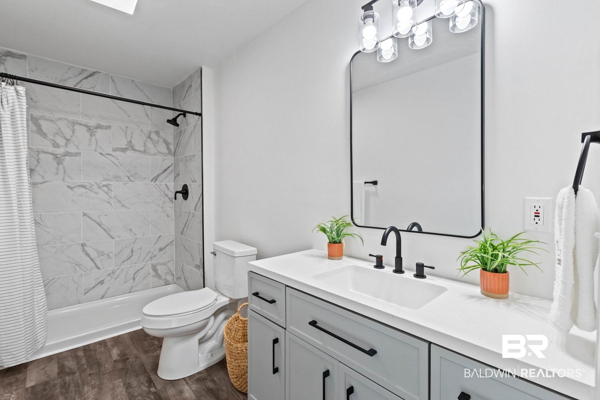128 Bush Avenue Mobile, AL 36604 - Photo 22 of 40 Bathroom with vanity, a stall shower, and dark wood-style floors