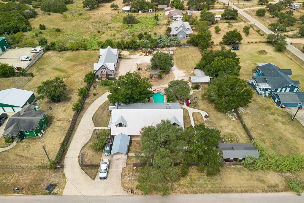 10111 Signal Hill Road Austin, TX 78737 - Photo 35 of 40 An aerial perspective showcases a spacious property complete with an in-ground pool.