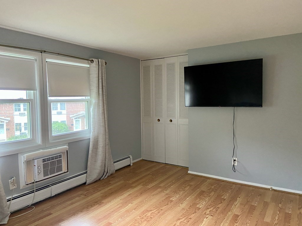 113 Manor Court, Unit 113 Springfield, MA 01118 - Photo 13 of 19 a view of a livingroom with an empty space and a window