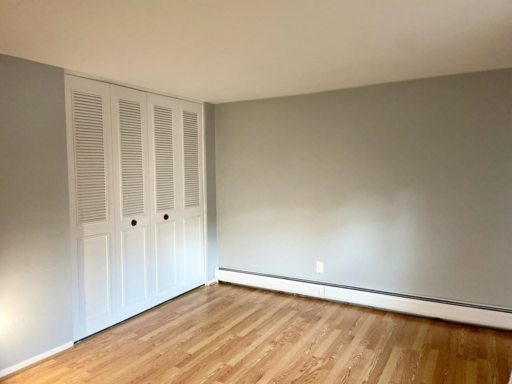 113 Manor Court, Unit 113 Springfield, MA 01118 - Photo 15 of 19 a view of an empty room with wooden floor