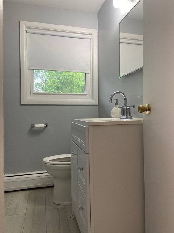 113 Manor Court, Unit 113 Springfield, MA 01118 - Photo 18 of 19 a bathroom with a toilet sink and window