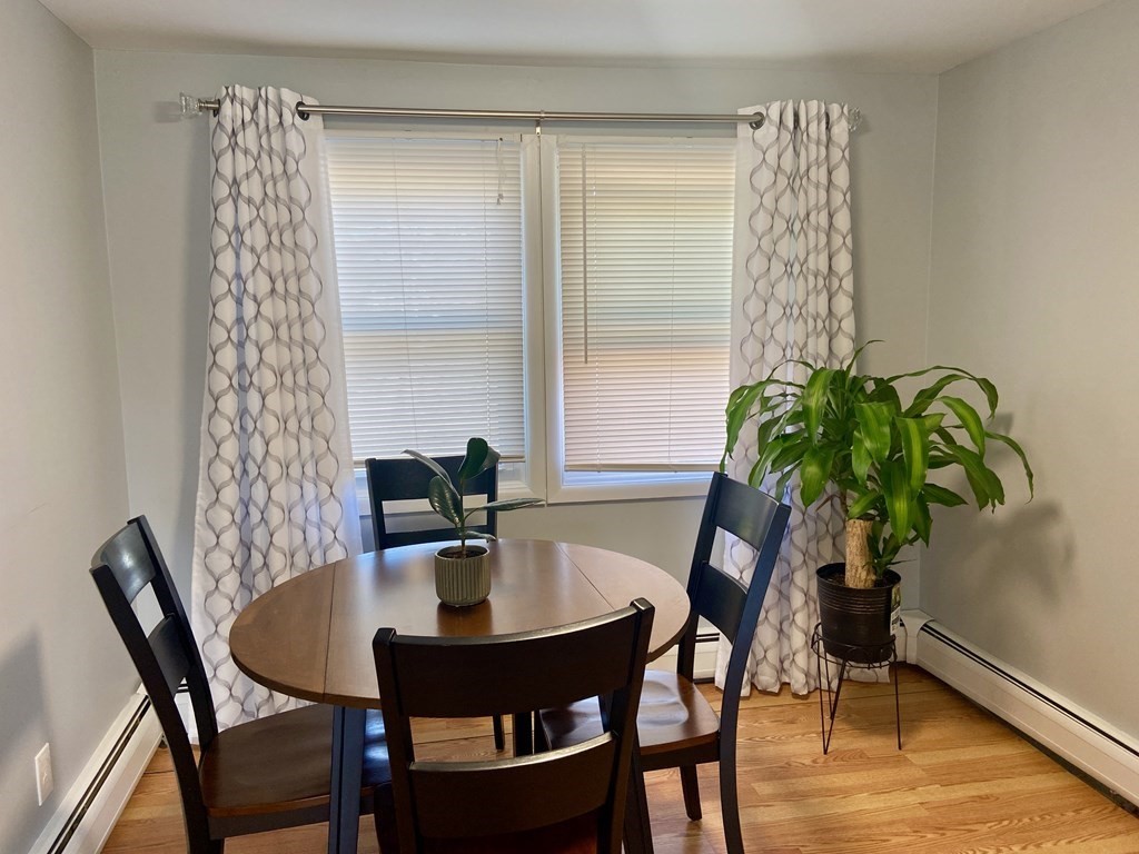 113 Manor Court, Unit 113 Springfield, MA 01118 - Photo 4 of 19 a view of a dining room with furniture window and wooden floor