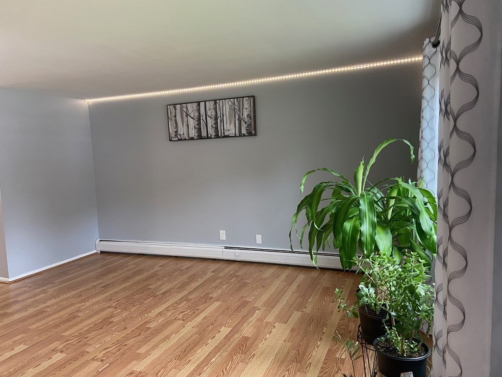 113 Manor Court, Unit 113 Springfield, MA 01118 - Photo 8 of 19 a view of a hallway with wooden floor