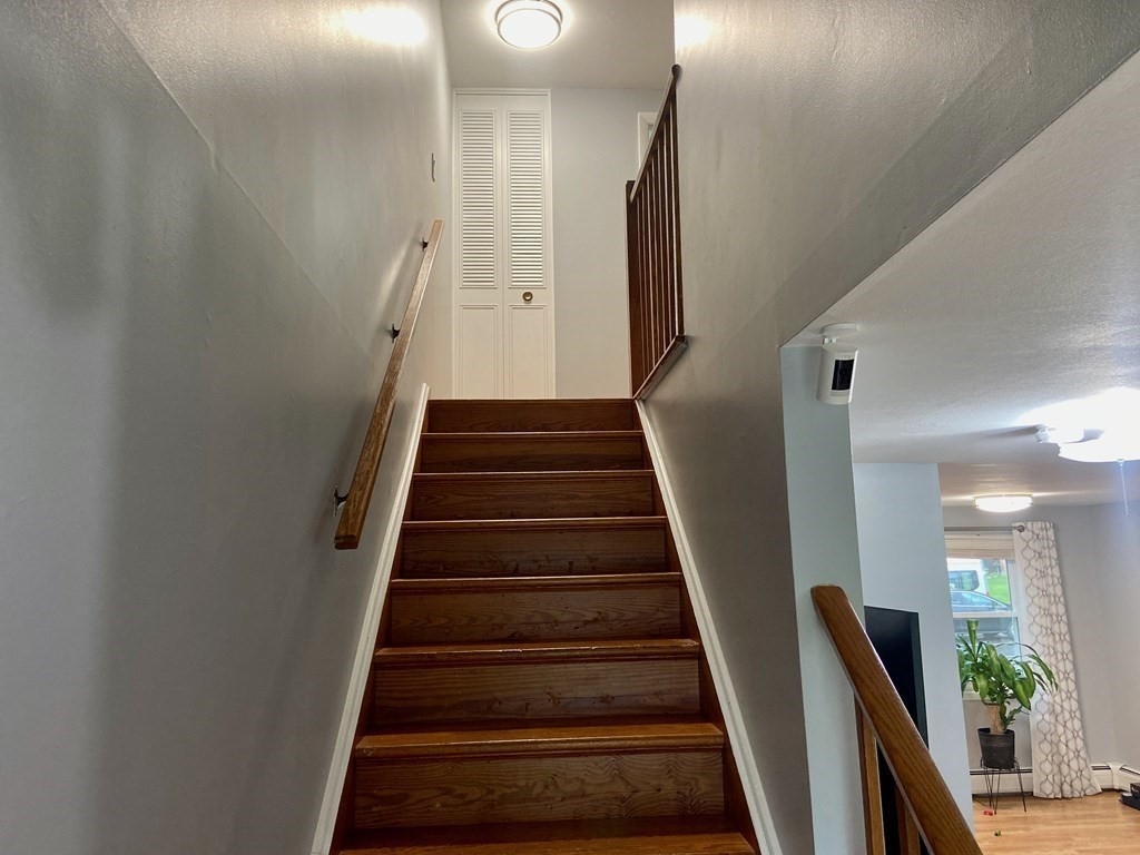 113 Manor Court, Unit 113 Springfield, MA 01118 - Photo 9 of 19 a view of staircase with lots of frames on wall and entryway