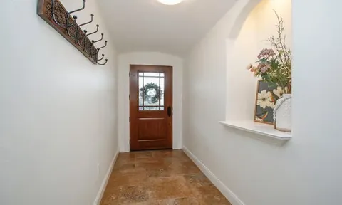 a living room with furniture a ceiling fan and a rug