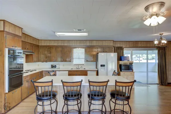 a dining table with chairs and chandelier