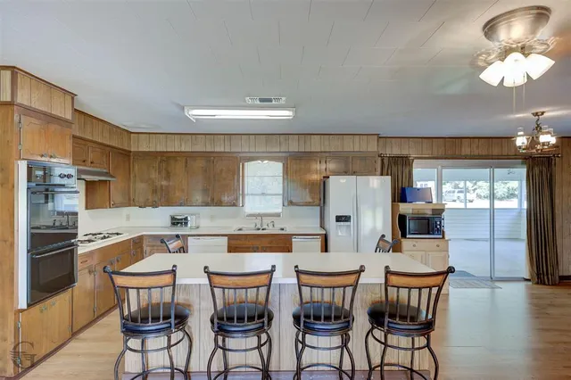 a dining table with chairs and chandelier