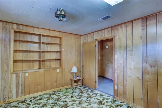a view of a hallway with wooden shelves