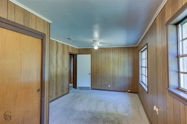 a view of entryway with wooden floor and cabinet