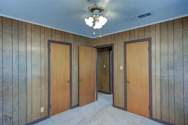 a view of a chandelier fan and closet area