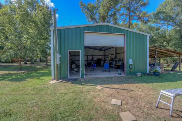 a view of a house with backyard porch and sitting area
