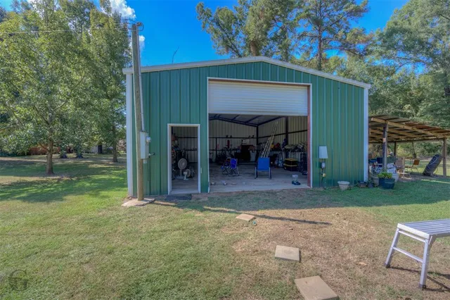 a view of a house with backyard porch and sitting area