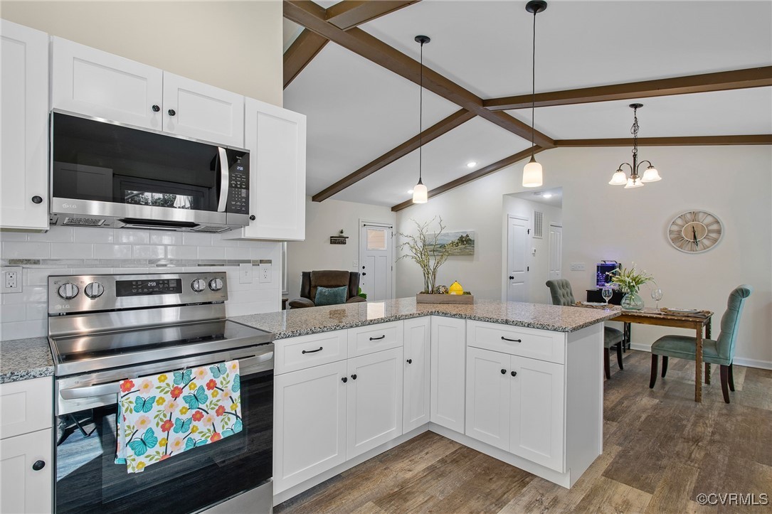 321 Johnson Mill Road Bumpass, VA 23024 - Photo 12 of 33 a kitchen with stainless steel appliances kitchen island granite countertop a stove and a sink