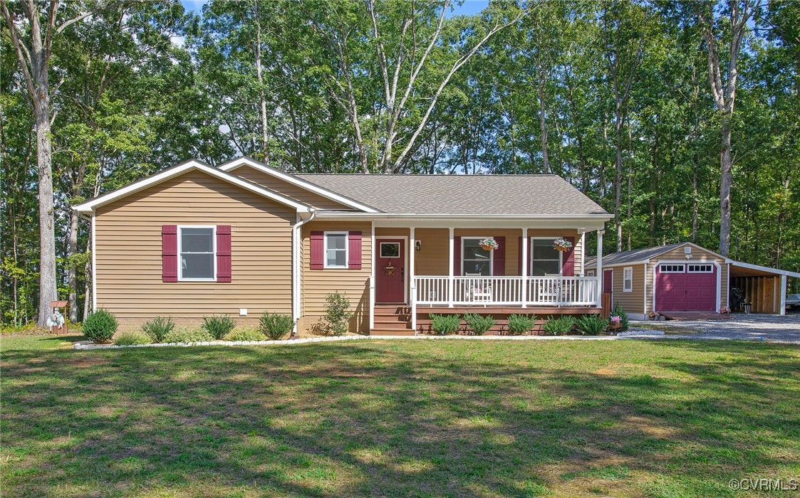 321 Johnson Mill Road Bumpass, VA 23024 - Photo 2 of 33 a front view of a house with a garden