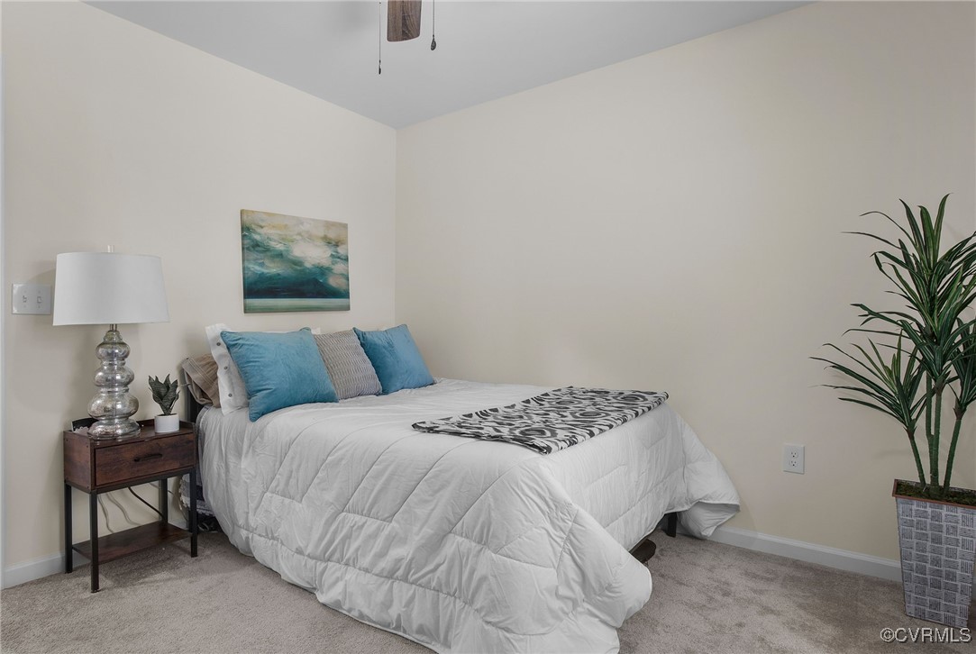 321 Johnson Mill Road Bumpass, VA 23024 - Photo 22 of 33 a bedroom with a bed and a potted plant