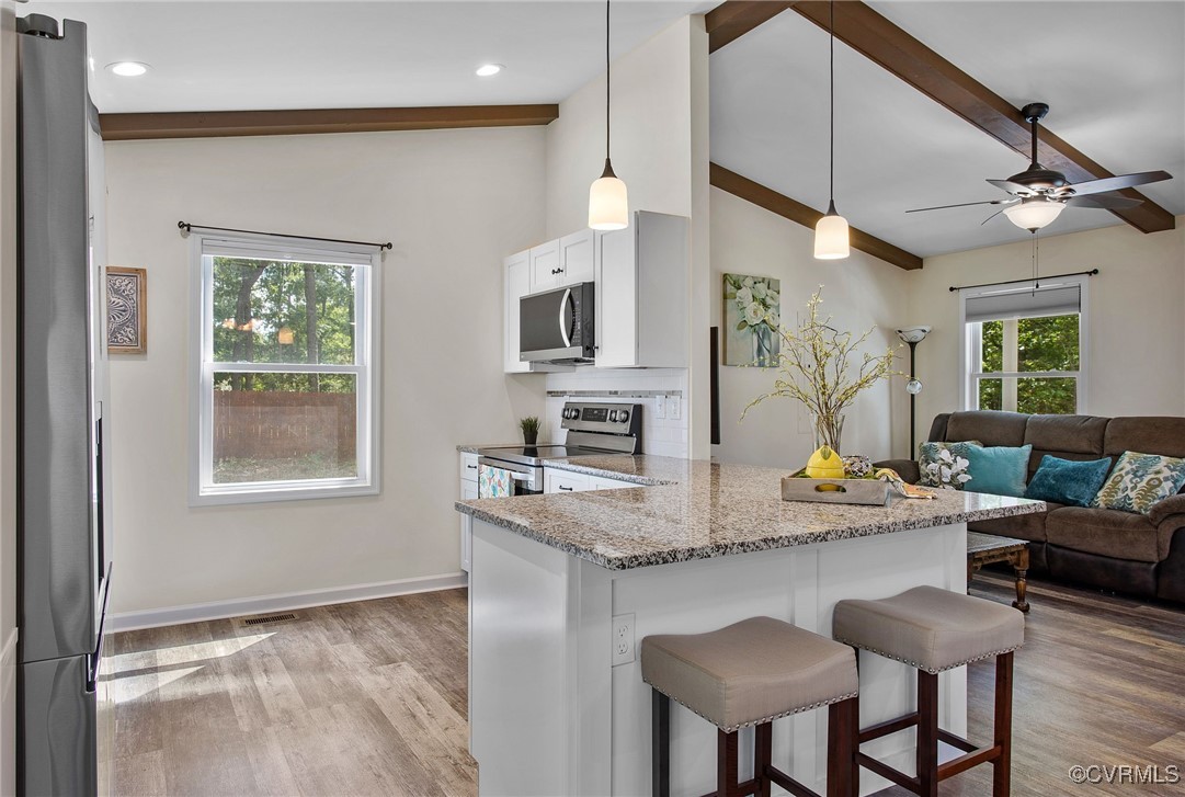 321 Johnson Mill Road Bumpass, VA 23024 - Photo 9 of 33 a kitchen with a table chairs refrigerator and microwave