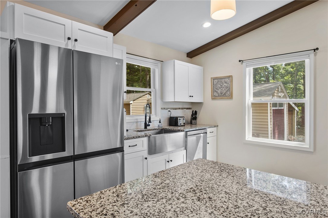 321 Johnson Mill Road Bumpass, VA 23024 - Photo 10 of 33 a kitchen with stainless steel appliances granite countertop a refrigerator sink and cabinets