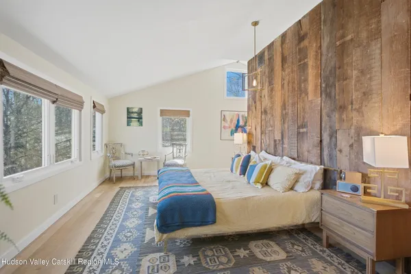 a bedroom with a bed and a television