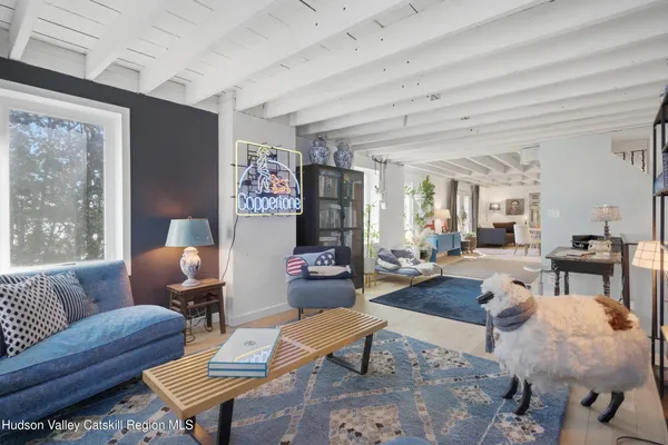 a living room with furniture and a lamp