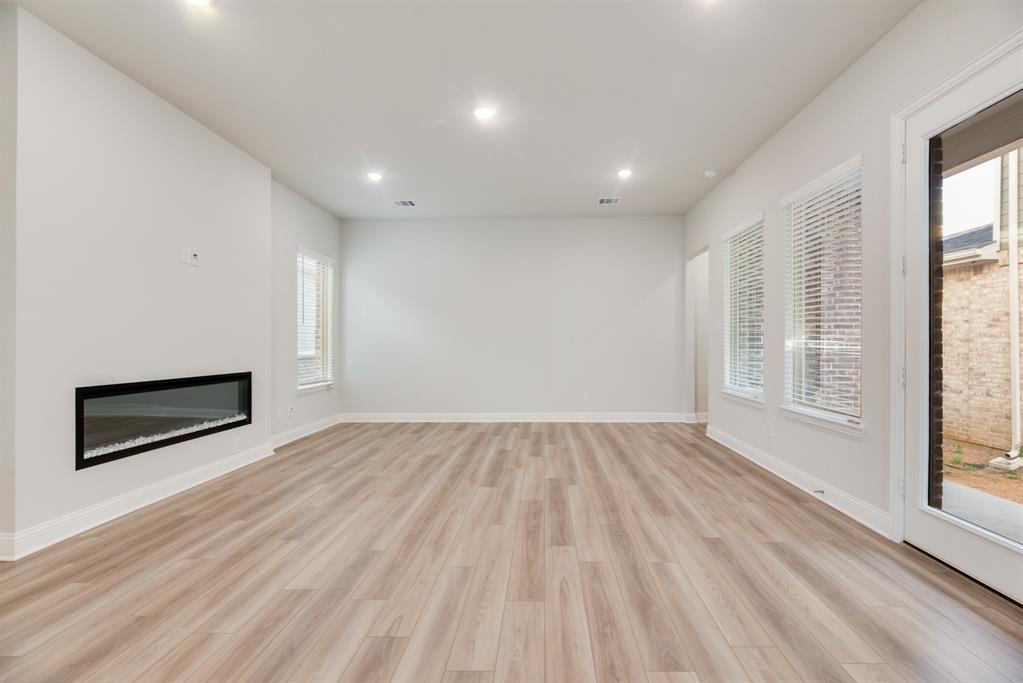 7009 Sunset Boulevard Rowlett, TX 75088 - Photo 14 of 35 wooden floor in an empty room with a window