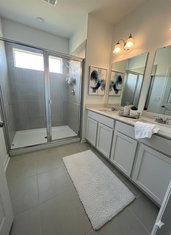 2626 Skyline Loop Kissimmee, FL 34758 - Photo 7 of 13 a bathroom with a sink a mirror and shower