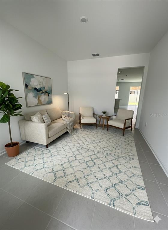 2626 Skyline Loop Kissimmee, FL 34758 - Photo 8 of 13 a living room with furniture and a potted plant