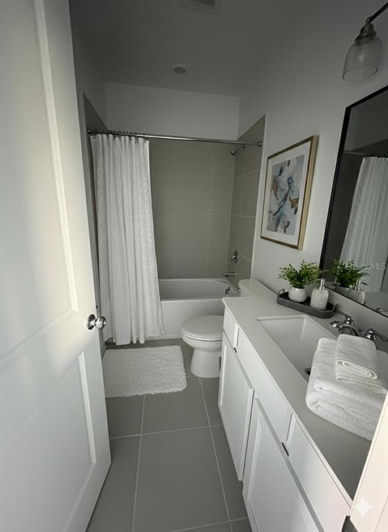 2626 Skyline Loop Kissimmee, FL 34758 - Photo 10 of 13 a bathroom with a granite countertop sink a toilet a mirror and shower