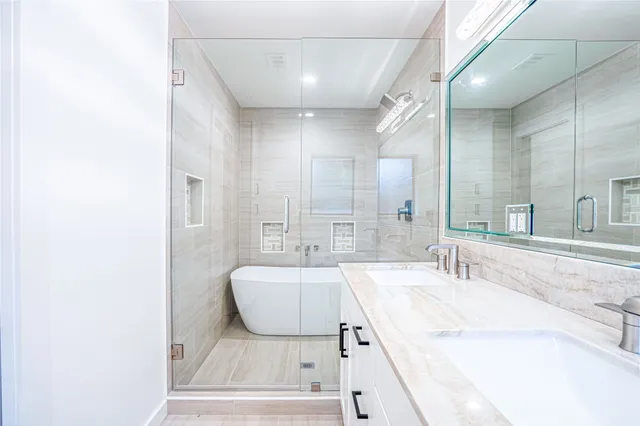a spacious bathroom with a tub sink and mirror