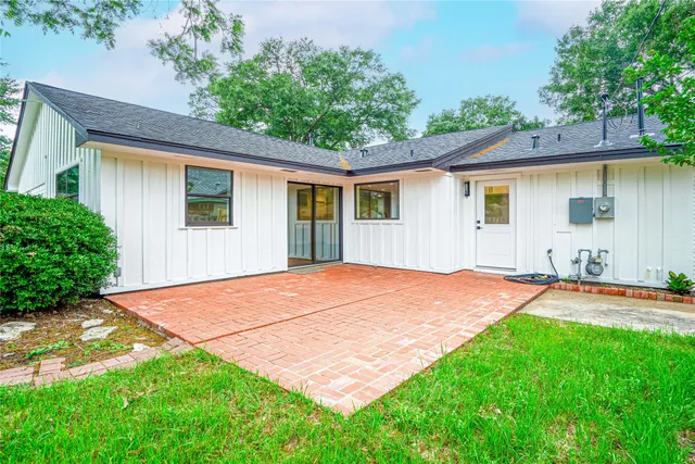 a backyard of a house with yard and outdoor seating