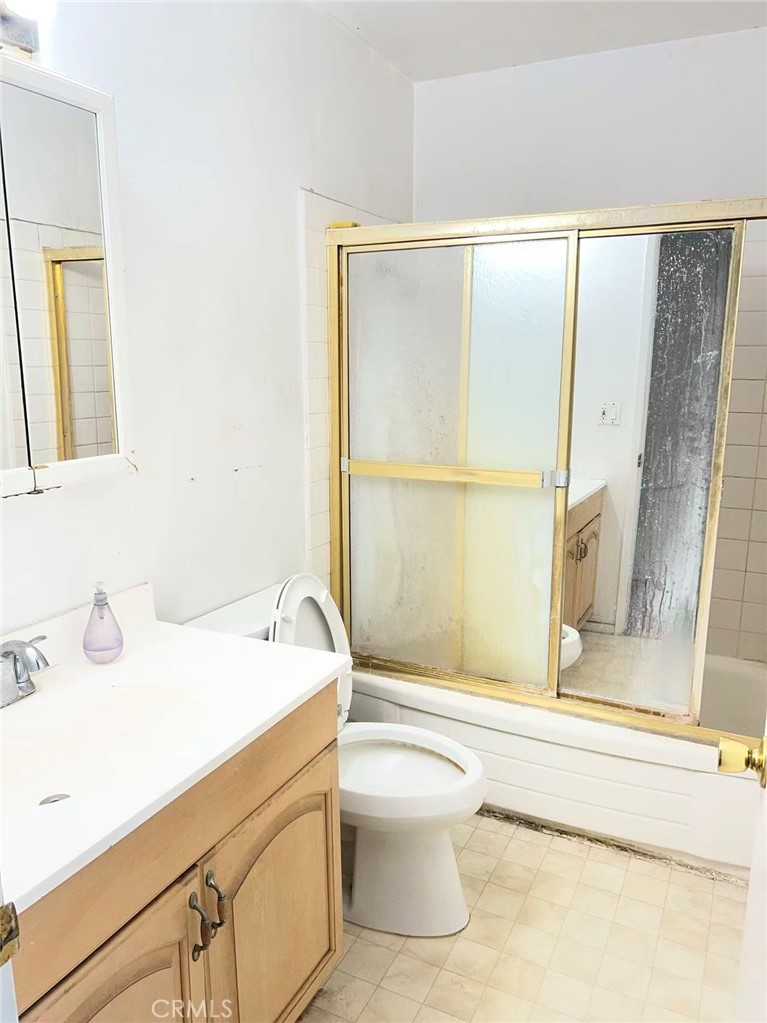 1777 Mitchell Avenue, Unit 92 Tustin, CA 92780 - Photo 12 of 13 a bathroom with a sink a toilet and shower
