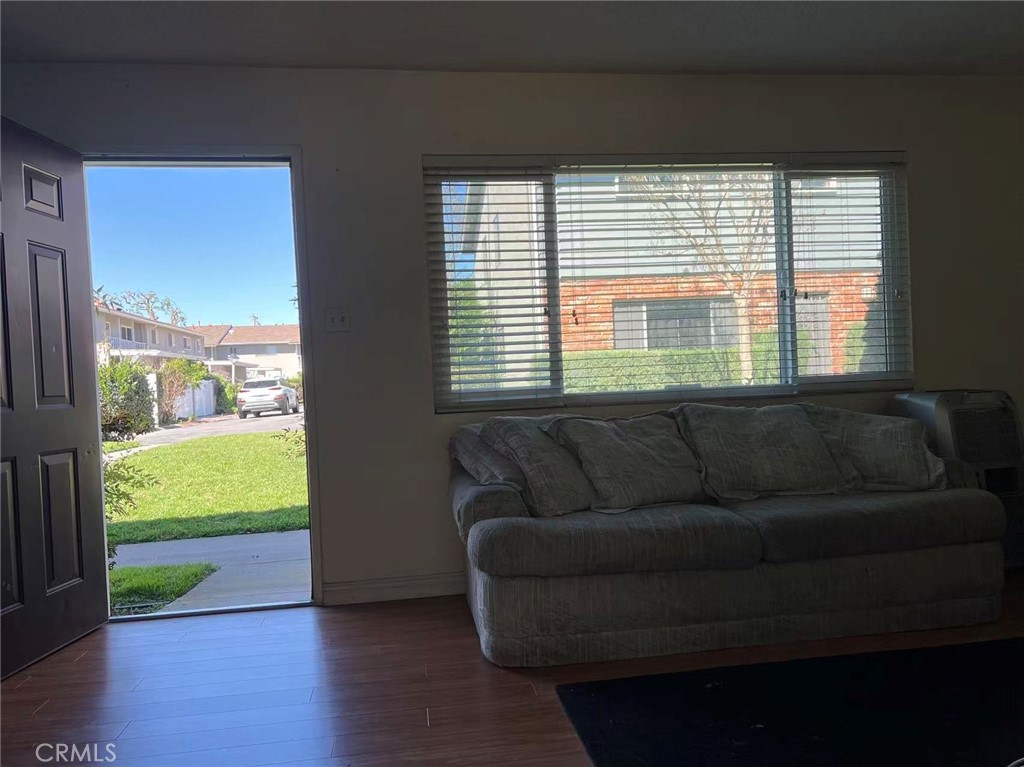 1777 Mitchell Avenue, Unit 92 Tustin, CA 92780 - Photo 4 of 13 a living room with furniture and a large window