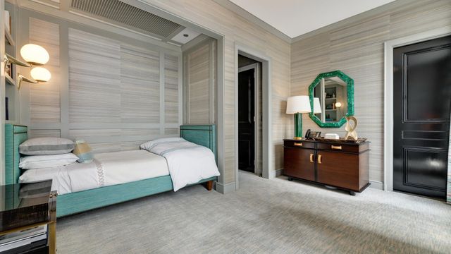 a bedroom with a bed and a dresser