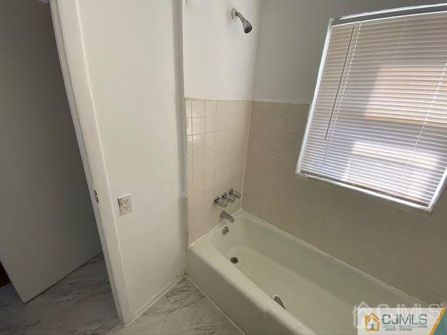 123 Kossuth Street Somerset, NJ 08873 - Photo 12 of 15 a bathroom with a tub a sink and a window