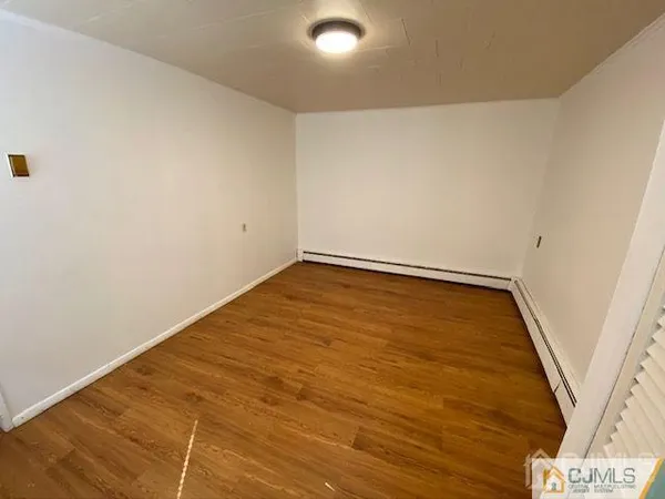 an empty room with wooden floor