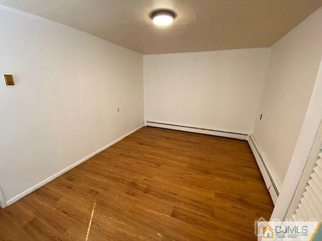 123 Kossuth Street Somerset, NJ 08873 - Photo 3 of 15 an empty room with wooden floor