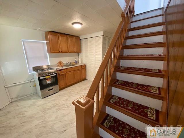 123 Kossuth Street Somerset, NJ 08873 - Photo 4 of 15 a kitchen with wooden cabinets and a stove top oven