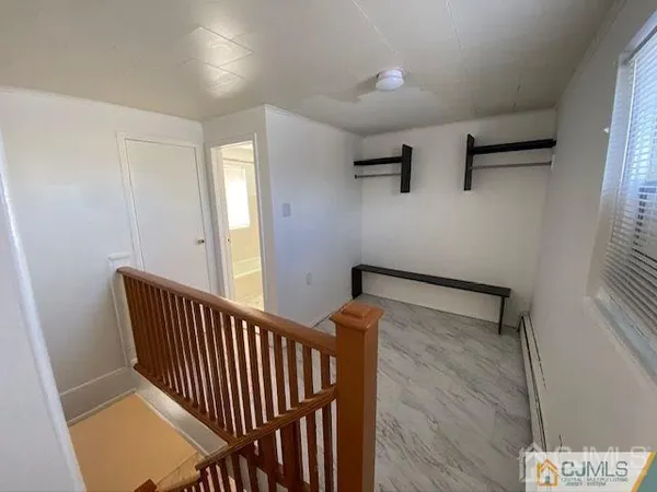a view of entryway with stairs and wooden floor