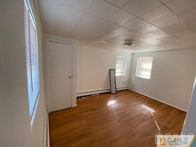 123 Kossuth Street Somerset, NJ 08873 - Photo 7 of 15 an empty room with wooden floor and windows