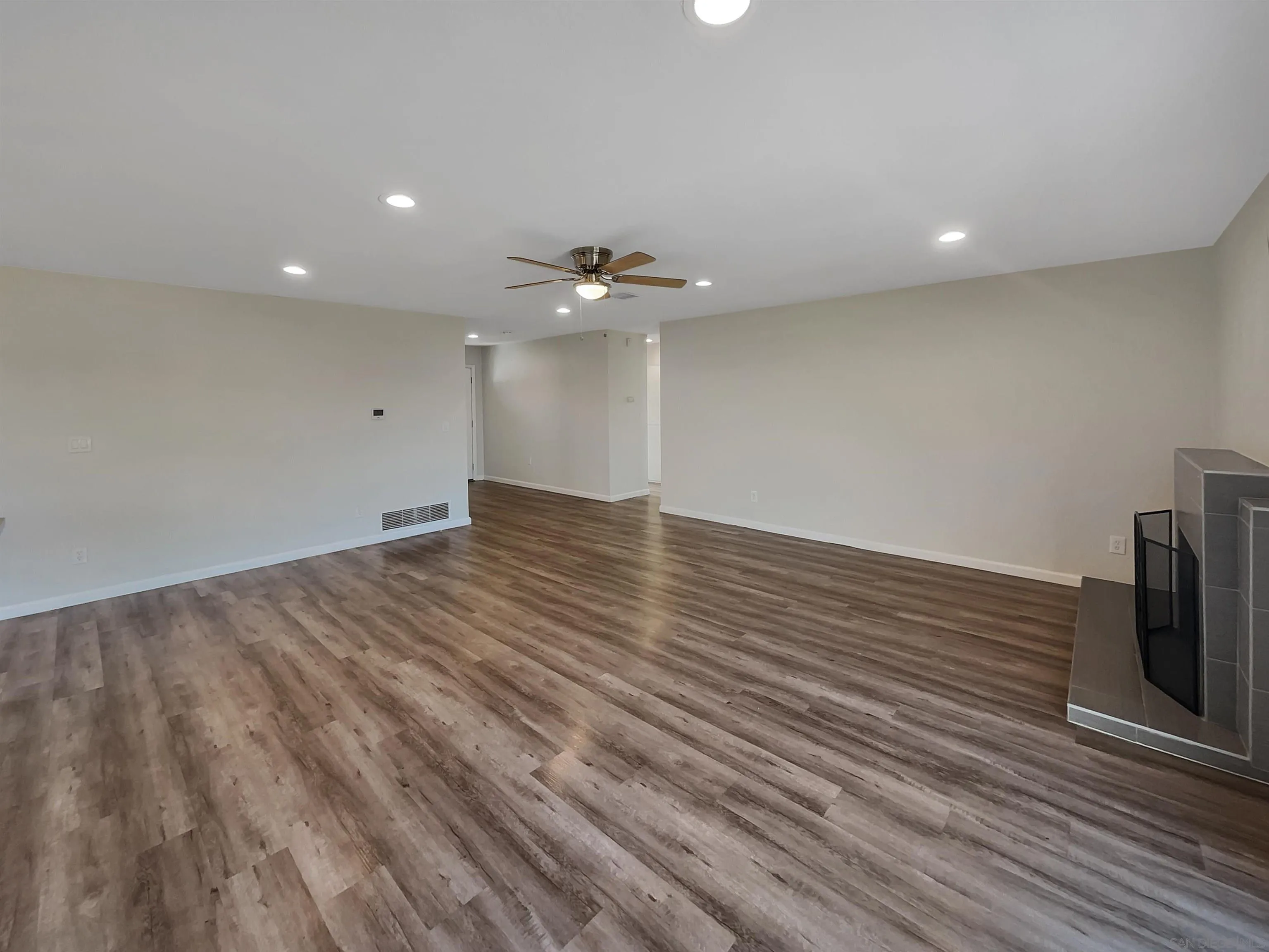 8238 Cacus Street Spring Valley, CA 91977 - Photo 11 of 22 an empty room with wooden floor and a ceiling fan