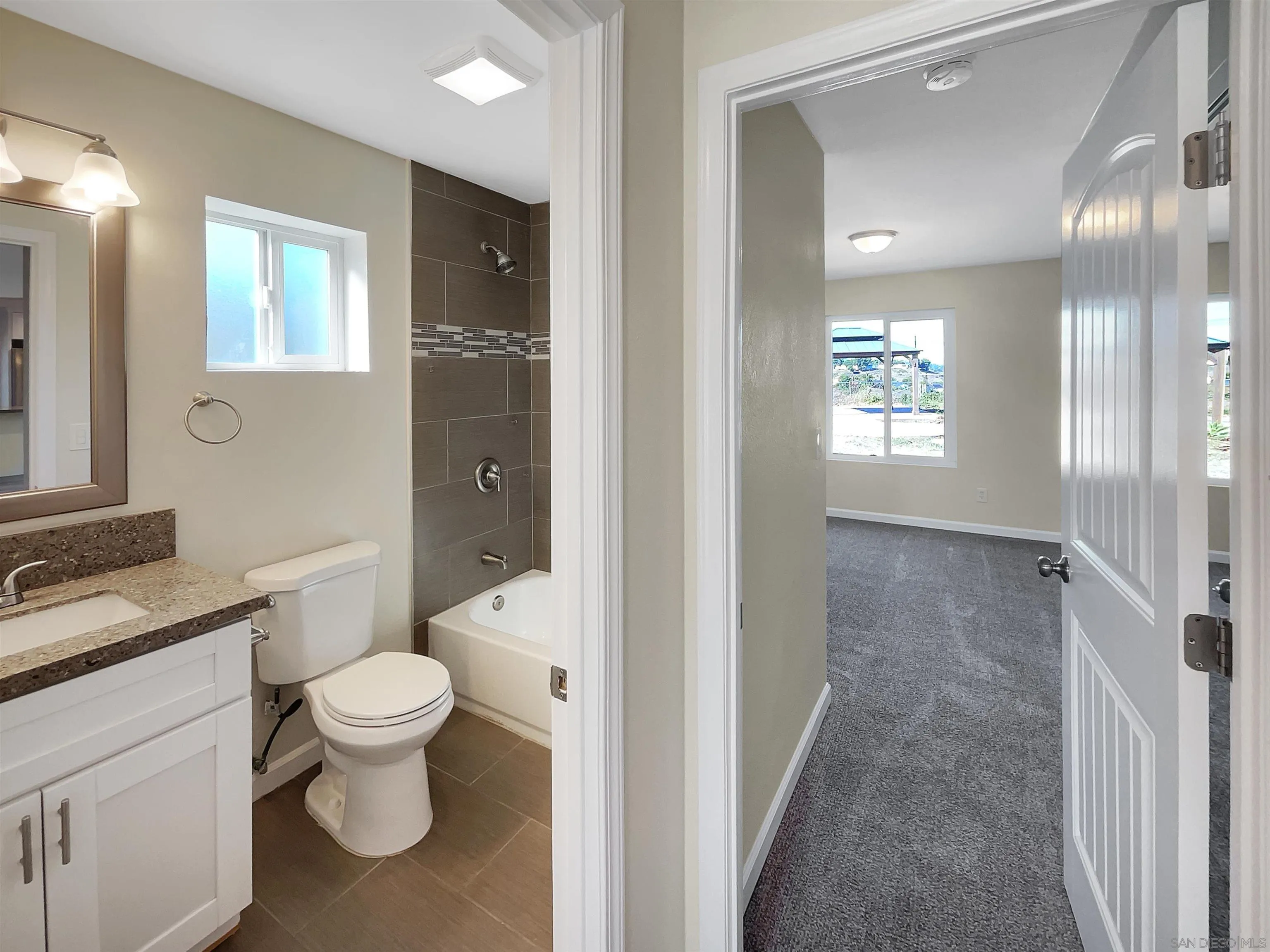 8238 Cacus Street Spring Valley, CA 91977 - Photo 13 of 22 a bathroom with a sink a toilet and shower