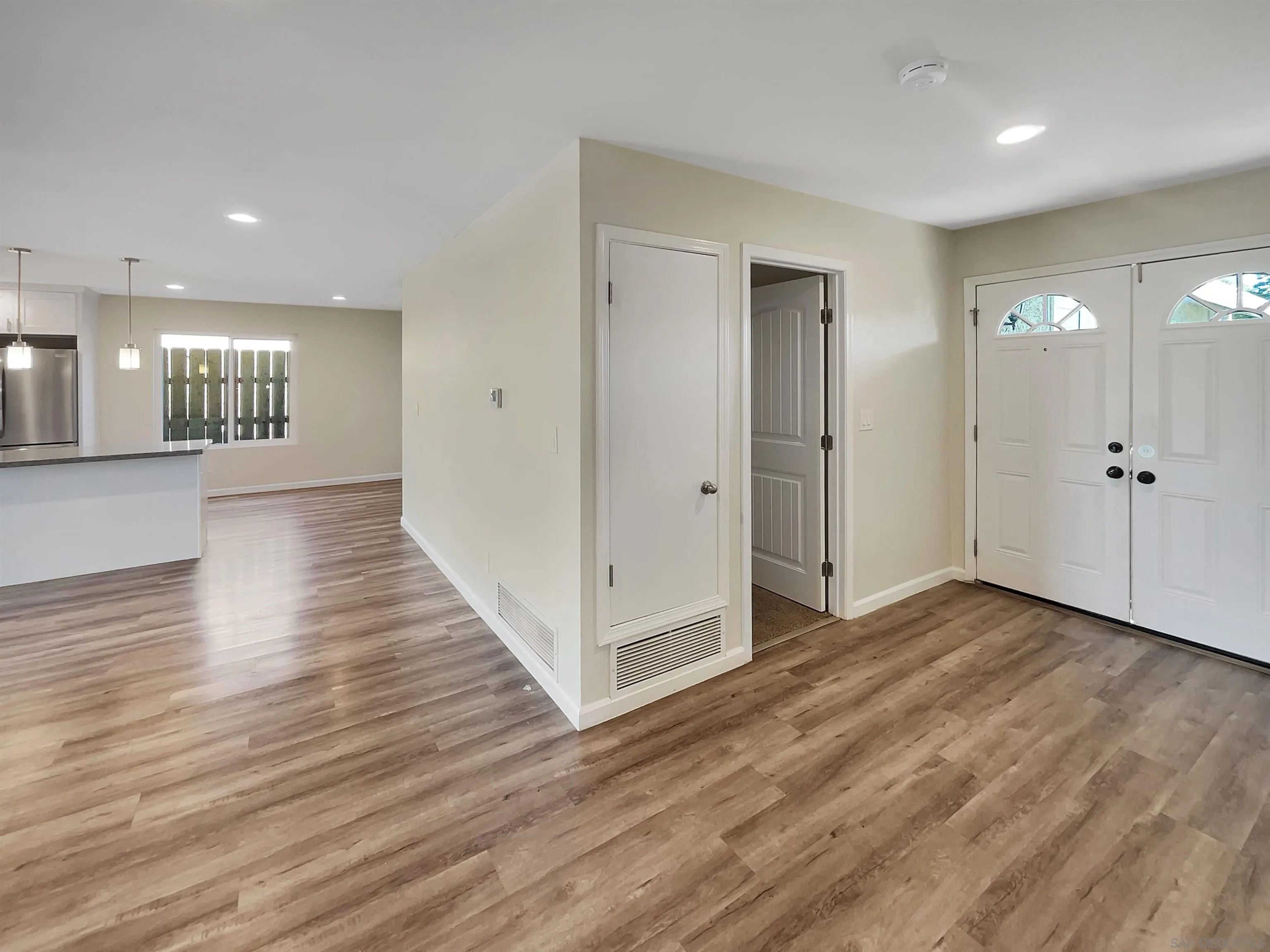 8238 Cacus Street Spring Valley, CA 91977 - Photo 17 of 22 an empty room with wooden floor and mirror